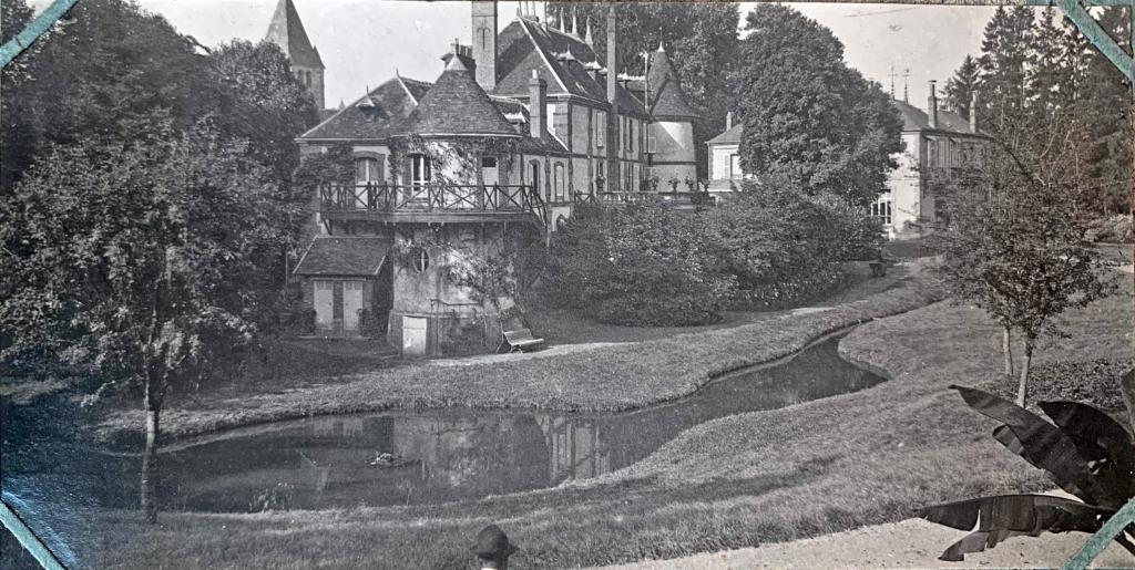 Les communs et le nouveau château Bianchi, vue générale depuis l'est, au quatrième quart du 19e siècle.- Reproduction d'un tirage photographique en noir et blanc (AD Orne, SHAO 1333).